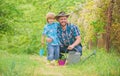 Take care of plants. Boy and father in nature with watering can. Spring garden. Dad teaching little son care plants Royalty Free Stock Photo