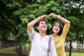 Take care and support concept,Portrait of elderly asian woman with daughter posture hand heart at outdoor together,Happy and smili Royalty Free Stock Photo