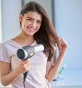 Take care of your hair. You wont be sorry. Cropped portrait of a beautiful young woman blowdrying her hair in the