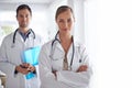 They take care of your health. Portrait of two young doctors standing in a hospital corridor. Royalty Free Stock Photo