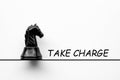 Take charge text with black knight chess on white cover background. Taking responsibility concept Royalty Free Stock Photo