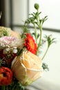 Close-up shots of various ornamental flowers by the window.