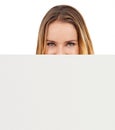 Take a closer look...A young woman looking over the side of a blank placard. Royalty Free Stock Photo