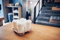 Take coffee to work for the entire office. High angle shot of a cardboard take out tray with four coffee cups with lids