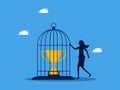 Take control of the victory. woman imprisoned the trophy in the birdcage. business concept Royalty Free Stock Photo