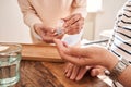 Nurse giving glass of water and pills to her senior patient Royalty Free Stock Photo