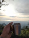 Take a cup of coffee while enjoying the beauty of rising sun at the top of the mountain Ranti