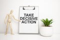 TAKE DECISIVE ACTION sign on small wood board rest on the easel with medical stethoscope