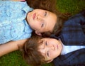Take A Deep Breath. High Angle Shot Of A Young Brother And Sister Holding Their Breath While Lying On The Grass Outside.