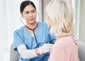 Take a deep breath for me. a female doctor examining a patient with a stethoscope. Royalty Free Stock Photo