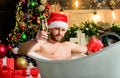 Take delight. Pampering myself. Winter holidays. New year. Mature man lying in bathtub drink champagne. Spa and wellness