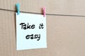 Take it easy. Note is written on a white sticker that hangs with Royalty Free Stock Photo