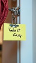 Take It Easy Reminder Note On Door With Key Symbolizing Relaxation And Stress Relief Royalty Free Stock Photo