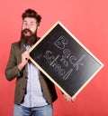 Take it easy. Teacher bearded man holds blackboard with inscription back to school red background. Teacher with tousled