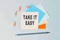 Take it easy - text on sticky note paper on gray background. Closeup of a personal agenda. Top view Royalty Free Stock Photo