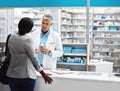 Take this on a empty stomach. a male pharmacist assisting a customer in a chemist.