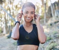 Take that first step today. a young woman using earphones while working out in nature. Royalty Free Stock Photo