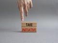 Take initiative symbol. Wooden blocks with words Take initiative. Businessman hand. Beautiful grey background. Business and Take