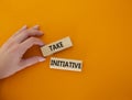 Take initiative symbol. Wooden blocks with words Take initiative. Businessman hand. Beautiful orange background. Business and Take