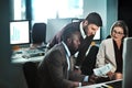 Take initiative. three businesspeople working together on a project in an open space.