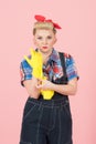 Take latex gloves on hand! Blonde young housewife taking on yellow latex gloves before cleaning. Pin-up modern style concept