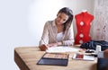 Take a look at the future of fashion. A fashion designer creating sketches in her office.