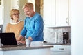 Take a look at this...a mature couple using their laptop in the kitchen. Royalty Free Stock Photo