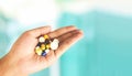 Take a medicine health care and people overdose concept - Many multi colors pills in hand woman Royalty Free Stock Photo