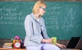 Take a minute break. Woman calm teacher holds mug drink sit table classroom chalkboard background. Working conditions Royalty Free Stock Photo