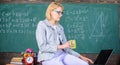 Take a minute break. Working conditions which prospective teachers must consider. Woman calm teacher holds mug drink sit Royalty Free Stock Photo