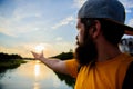 Take moment to admire sunset nature beauty. River sun reflection. Man in cap enjoy sunset while stand on bridge. Enjoy