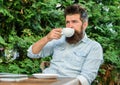 Take moment to enjoy life. Man bearded hipster make pause for drink coffee and relax while sit with laptop. Guy drinks
