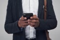 Take my number, youll be needing it later. Studio shot of an unrecognisable businessman using a smartphone against a