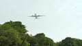 Take-off aircraft on the background of the jungle and trees in Indonesia. Royalty Free Stock Photo