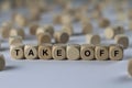 Take off - cube with letters, sign with wooden cubes Royalty Free Stock Photo