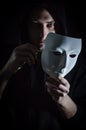 Take off the mask - Portrait of a young hooded man who takes off his mask, letting his gaze be seen, concept for being true Royalty Free Stock Photo