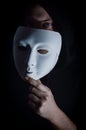 Take off the mask - Portrait of a young hooded man who takes off his mask, letting his gaze be seen, concept for being true Royalty Free Stock Photo