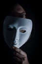 Take off the mask - Portrait of a young hooded man who takes off his mask, letting his gaze be seen, concept for being true Royalty Free Stock Photo