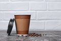Take-out blank paper brown coffee cup with black cover, craft cup holder and beans Royalty Free Stock Photo