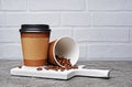 Take-out blank paper brown coffee cups with black covers, craft cup holders and beans Royalty Free Stock Photo