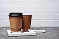 Take-out blank paper brown coffee cups with black covers, craft cup holders and beans Royalty Free Stock Photo