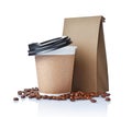 Take-out blank paper coffee cup with black cover, craft cup holder, beans and brown packet Royalty Free Stock Photo