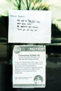 Take-out only and Covid-19 health notices taped to door of restaurant during time of Coronavirus pandemic