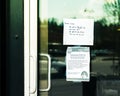 Take-out only and Covid-19 health notices taped to door of restaurant during time of Coronavirus pandemic