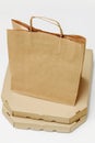 Take-out food containers, pizza box and paper bag, close-up. white background Royalty Free Stock Photo