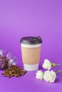 Take-out coffee in closed paper cup with beans Royalty Free Stock Photo