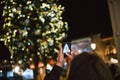 Take a photograph the illuminated and decorated Christmas Market fir tree