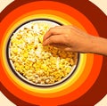 Take popcorn on a colorful background