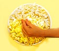 Take popcorn on a yellow background