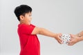 Take this present! Side view of cheerful generous good-natured little boy offering gift box and smiling happily